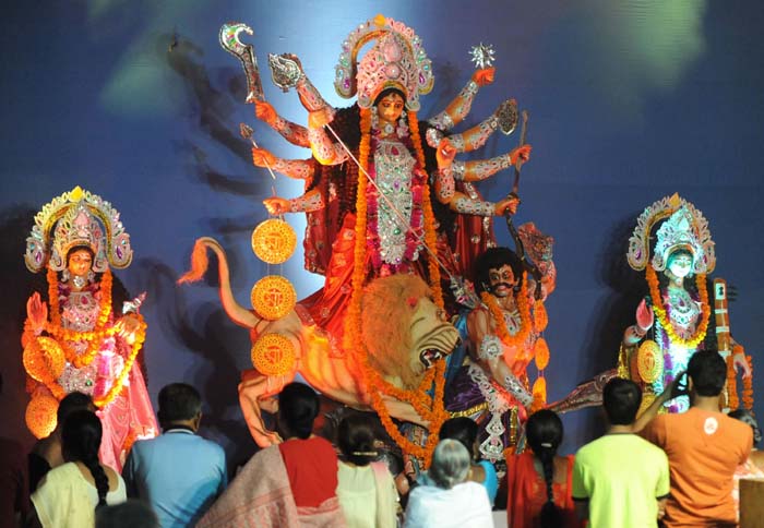 Devotees offer prayers to Goddess Durga in Hyderabad on September 24, 2009. The complete image of Goddess Durga represents the destruction of evil and protection of good. It also enforces that in order to become divine one should keep one's animal instincts under control. (AFP PHOTO)