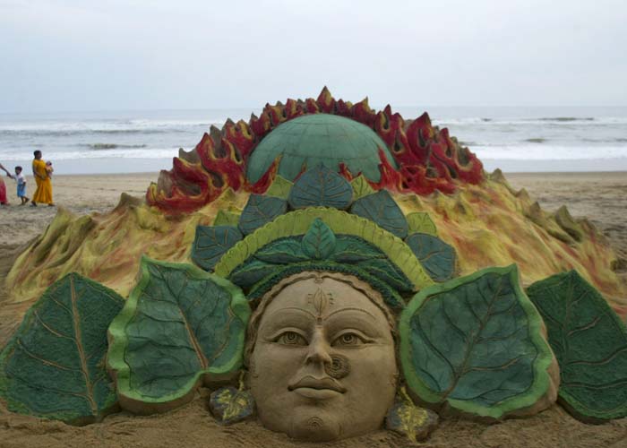 A sand sculpture of Goddess Durga alongside a burning globe, urging her to save the world from global warming, is seen on the beach commemorating the festival of Durga Puja, at Puri, about 67 kilometers from Bhubaneshwar on Wednesday, September 23, 2009. The five-day long festival, that began on Thursday commemorates the story of the lion-riding, 10-armed goddess Durga&rsquo;s slaying of a demon king, celebrating the triumph of good over evil. (AP Photo)