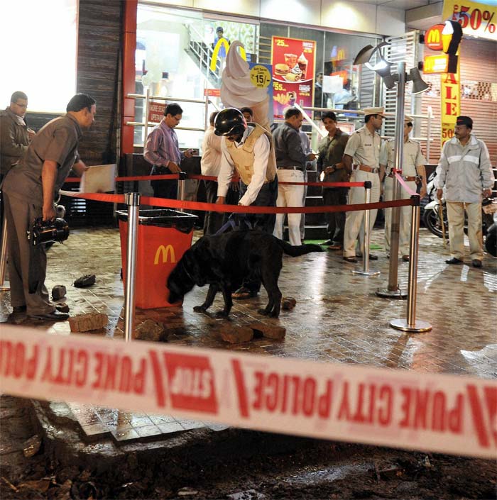 Police and bomb detection and disposal squad (BDDS) examine a dustbin on Junglee  Maharaj road where one of the blasts took place on Wednesday evening.