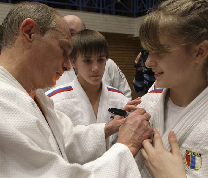 After the judo session, the Russian Prime Minister also took time to pose for photos with some of the judokas and to hand out autographs. (AP Photo)