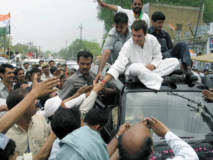 His candidacy was greeted with excitement by locals, who had a long standing affinity with the family's presence in the area. He won with a landslide majority, retaining the family stronghold with a huge margin as the Congress unexpectedly defeated the ruling Bharatiya Janata Party. His campaign was masterminded by his younger sister, Priyanka. In this April 23, 2004 file photo Rahul is seen sitting on a roof of a car as he shakes hands with supporters during election campaigning in Varanasi, Uttar Pradesh. (Photo: AFP)