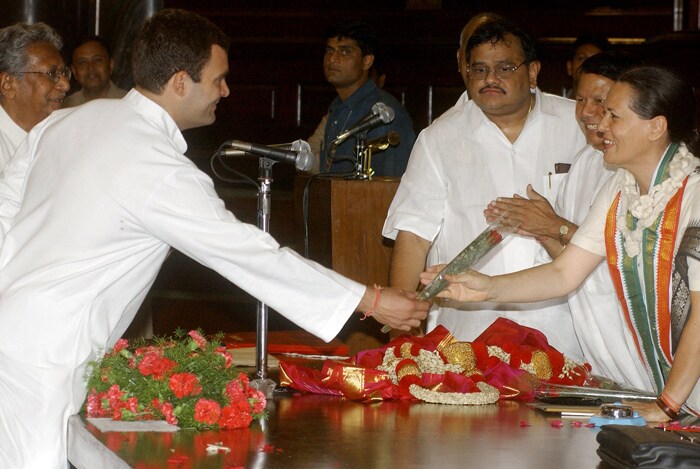 In this May 15, 2004 file photo, Congress President Sonia Gandhi smiles after being given a rose by her son and newly elected Member of Parliament Rahul Gandhi during a Congress parliamentary party meeting at the Parliament House in New Delhi. Sonia confounded her political opponents by nominating Dr Manmohan Singh as India's Prime Minister, a post that many had expected her to fill after leading the Congress party to a spectacular victory in the 2004 general elections. (Photo: AFP)