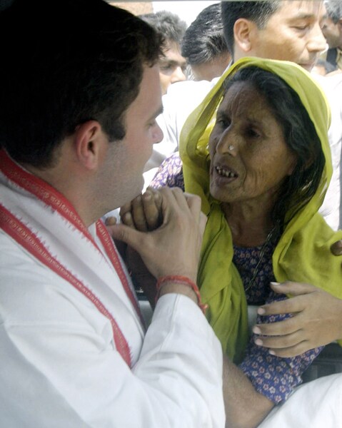 Speculation heightened in January 2004 about his possible entry into politics when he visited his father's former constituency of Amethi. He refused to give a definitive response, stating "I am not averse to politics. I have not decided when I will enter politics and indeed, if I ever will." <br><br>In March 2004, he announced his entry into politics by declaring his intention to contest the May 2004 elections, standing from Amethi. In this March 29, 2004 file photo, Rahul Gandhi speaks to an elderly woman as she holds his hand during his visit to Jamon village near Amethi. (Photo: AFP)