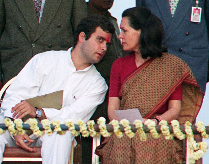 Despite his reluctance to enter active politics, Rahul's growing visibility on the campaign trail could not be ignored. In this February 13, 1998 file photo Sonia Gandhi is seen conferring with her son upon their arrival for an election rally. (Photo: AFP)