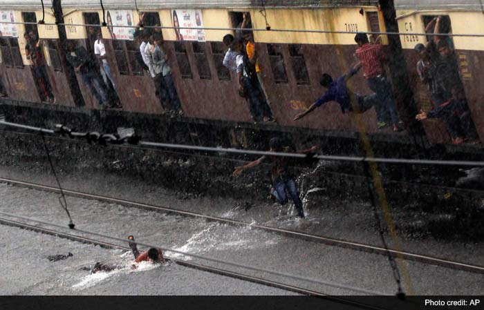 Seen here, a city bus makes its way through a flooded street in Bandra.