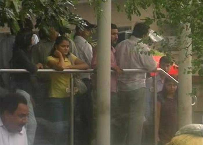 Passengers waiting outside the Metro station due to the heavy downpour.