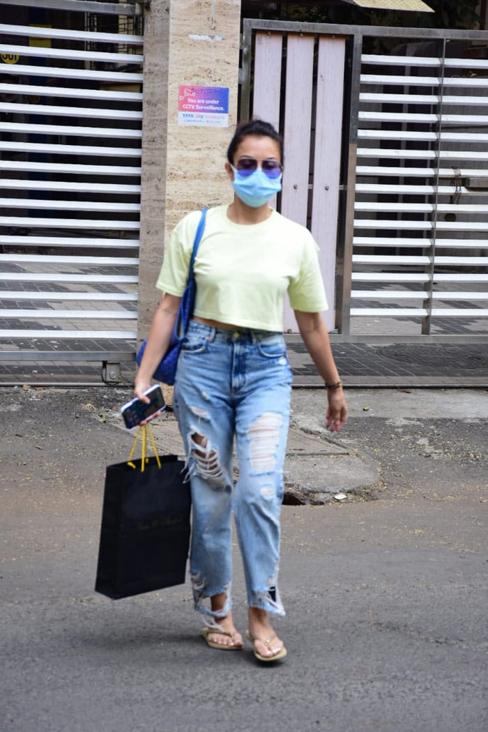 Seema Khan wore a crop top along with a pair of denims for her day out.