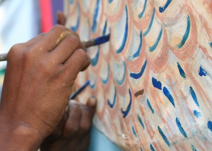 <strong>A dash of blue:</strong> An artist puts the finishing touches to a backdrop frame. (NDTV Photo)