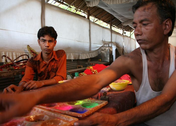 <strong>The lull:</strong> The master artisan brings out his tools of the trade. He stills himself before the moment when he shall paint expression on to the faces of hundreds of characters. (NDTV Photo)