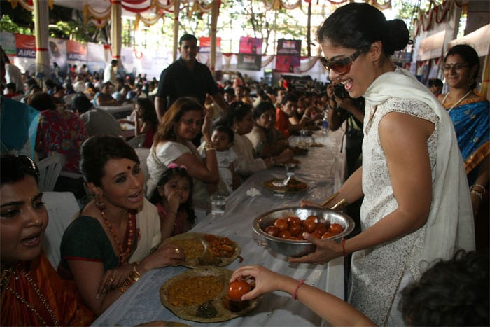 Kajol serves food to Rani Mukherjee and her family at the Durga Puja pandal in Mumbai. (Photo: IANS)