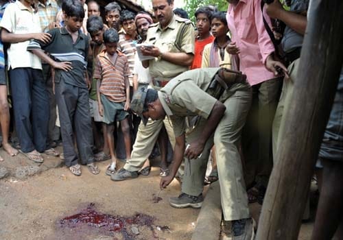 <b>Victims or perpetrators?</b> A policeman inspects a patch of blood where three CPM workers were killed by Maoist activists at Bankshole village in Midnapore, some 200 kms west of Kolkata after days of clashes between tribal villagers and police. The Naxals said they were fighting for the rights of neglected tribals and landless farmers. (AFP)