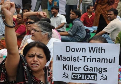 <b>And raise our voice:</b> Activists of the Communist Party of India-Marxist (CPM) shout slogans against Maoists and the Congress-led UPA government as they 

condemned the killing of their cadres by alleged Maoists in the West Midnapore district of West Bengal, during a protest in New Delhi. (AFP)