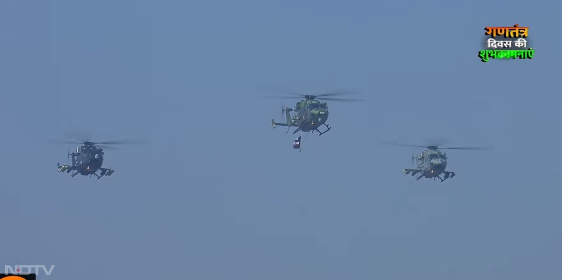 दिल्ली में कर्तव्य पथ पर ऑपरेशन सिंदूर का झंडा लिए भारतीय वायु सेना के हेलीकॉप्टर उड़ाए जा रहे हैं, जिनसे पुष्प वर्षा की जा रही है.