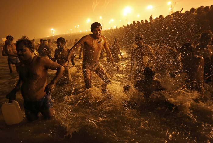 Once every 12 years, millions of Indians gather for one of Hinduism's holiest celebrations at the Sangam. In this January 14 photo, a man jumps in the water as he takes a dip during <i>shahi snan</i> or holy bath.