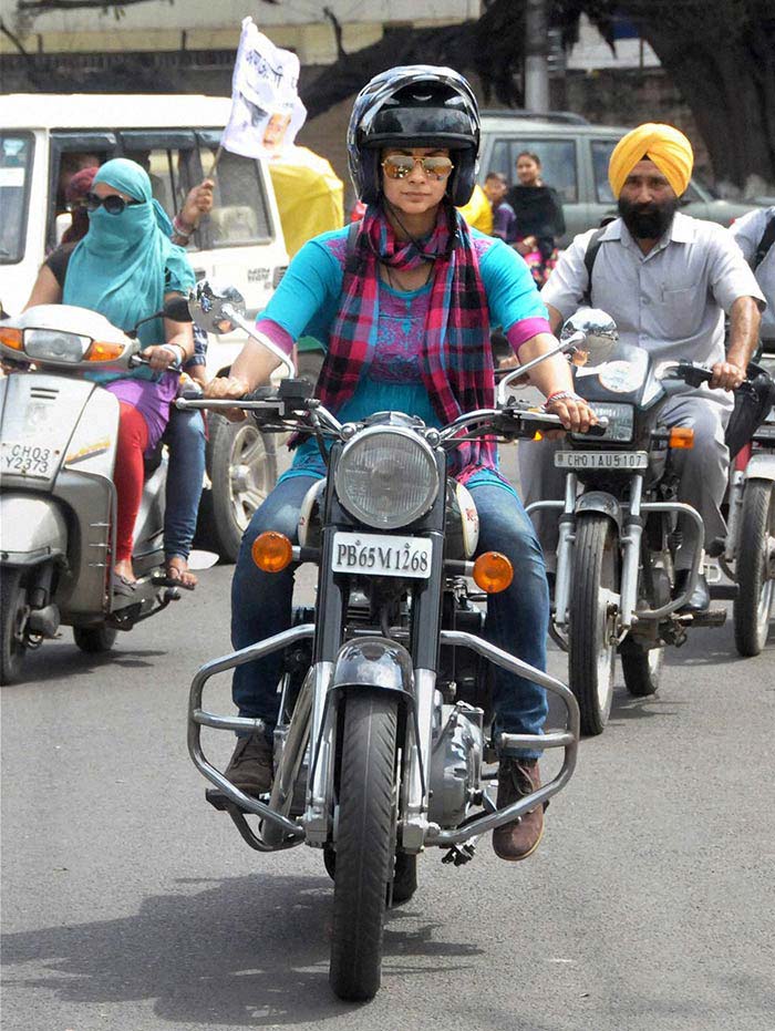 AAP candidate Gul Panag rides a Royal Enfield 350 cc bike while campaigning in Chandigarh.