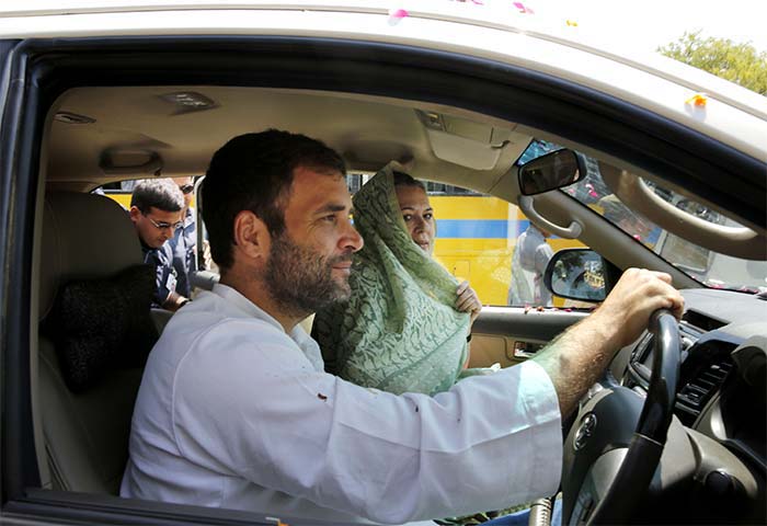 Congress party Vice President Rahul Gandhi drives his mother and party President Sonia Gandhi in a white SUV to file her nomination papers for the upcoming general elections, in Raebareli, in Uttar Pradesh.