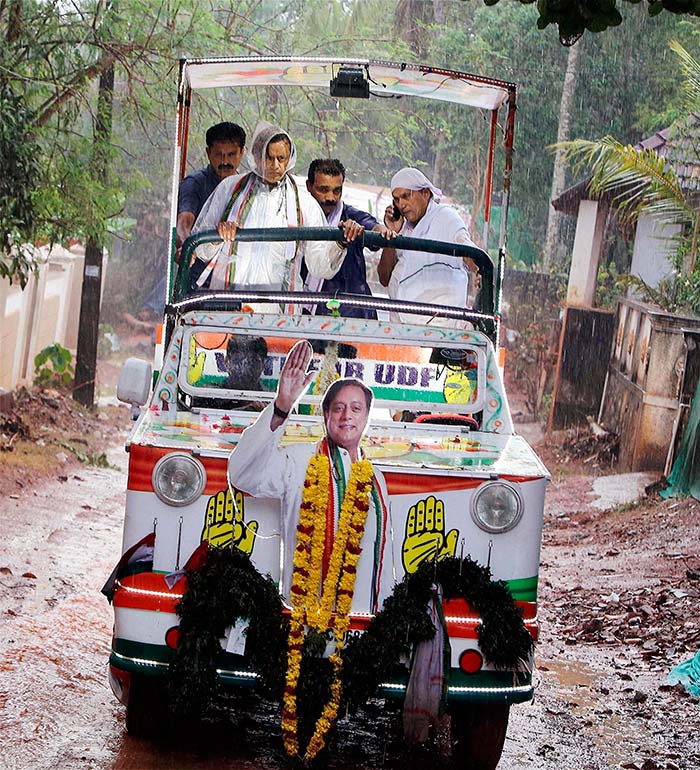 Congress candidate Shashi Tharoor braves the rain during his door-to-door campaign at Perumbazhuthor on the outskirt of Thiruvananthapuram. He is travelling in a custom made vehicle for campaigning purposes.