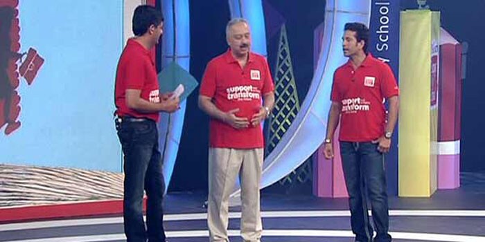 Sachin and Vikram Chandra on the stage with Atul Singh of Coca Cola.