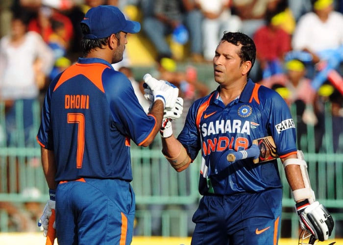 Sachin Tendulkar is congratulated by his Indian captain Mahendra Singh Dhoni after scoring a century during the Compaq Cup tri-series final match against Sri Lanka in Colombo. (AFP Photo)