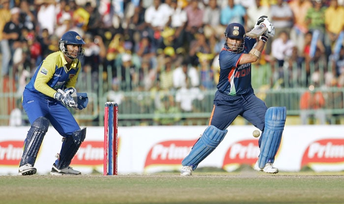 Sri Lanka's team captain Kumar Sangakkara takes his position as India's Sachin Tendulkar plays a shot during their final tri-nation series in Colombo. (AP Photo)