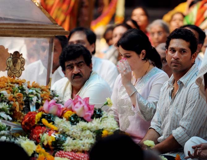 He also spoke to an official of Sathya Sai Central Trust sitting beside him. (AFP Photo)