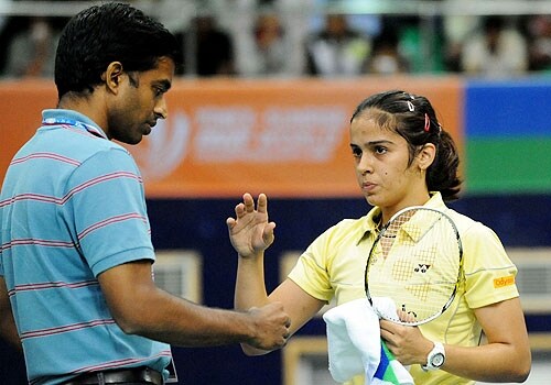 <span class="lh16 fa fs12 fb">Saina Nehwal speaks with her coach P.Gopichand during a break in her womens singles match against Anastasia Prokopenko of The World Badminton Championship at The Gachibowli Stadium in Hyderabad. (AFP Photo)</span>