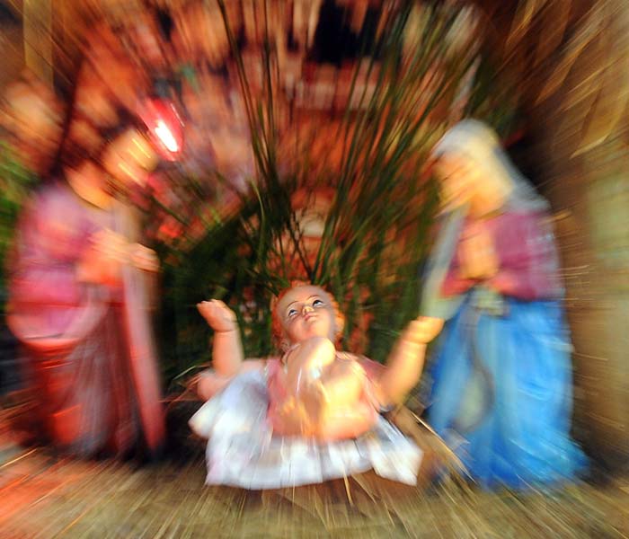 It's that time of the year again: cakes, prayers, gifts and wishes galore as Santa comes calling. This slow shutter speed photograph taken on December 25, 2010 shows the nativity scene during a Christmas mass in Colombo. (Photo courtesy: AFP)