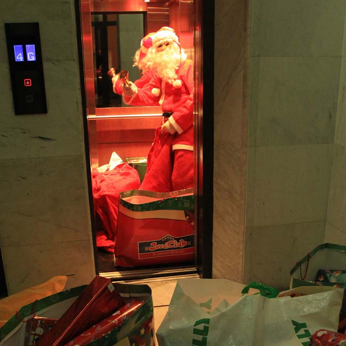 Santa Claus rides an elevator with bags of gifts as he readies to visit a residential apartment on Christmas Eve in the Lebanese capital Beirut, on December 24, 2010. (Photo courtesy: AFP)