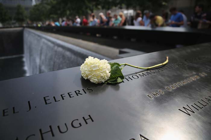 A flower lies atop names of victims at the 9/11 Memorial.