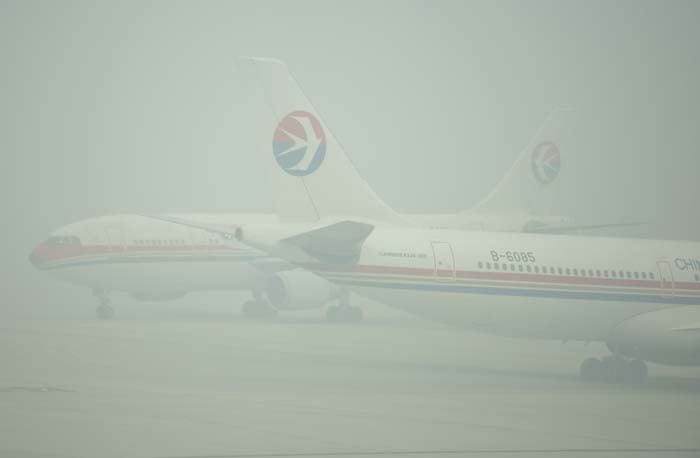 The smog forced the city's two airports to cancel or delay hundreds of flights on Friday.