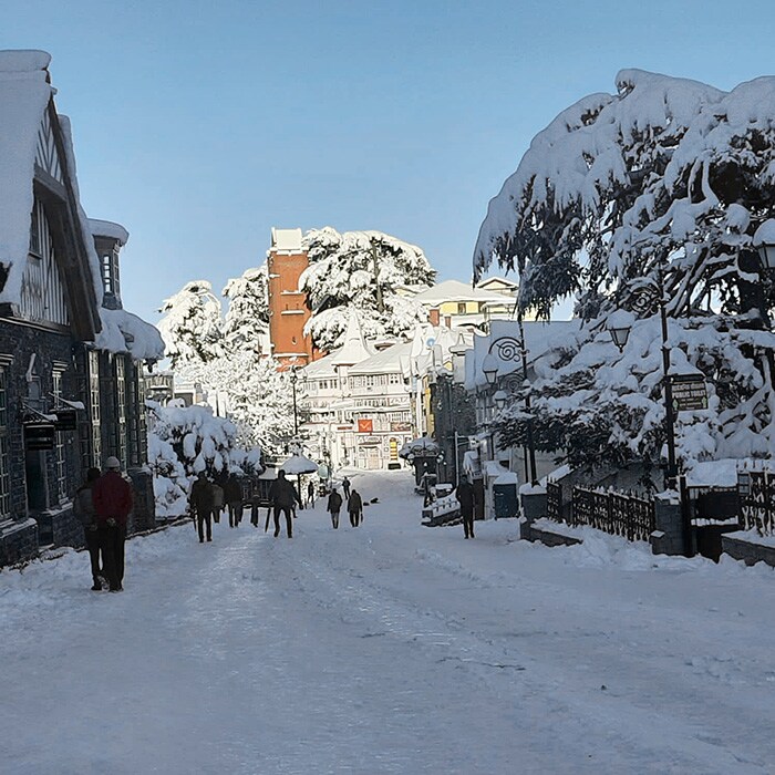 Mall Road covered with a thick layer of snow following heavy snowfall, in Shimla on Saturday. (ANI Photo)