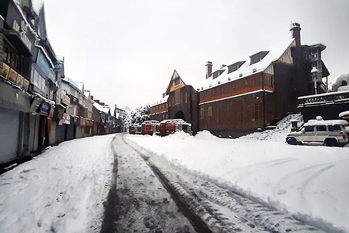 Mall Road is covered with a thick layer of snow following heavy snowfall, in Shimla on Sunday.