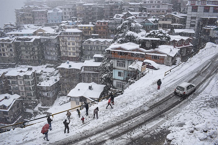 A Shimla neighbourhood is seen covered in snow after a fresh spell of snowfall in Shimla, Sunday, Jan. 23, 2022.