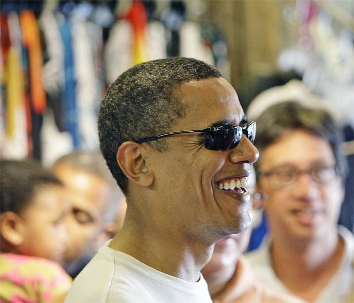 President Barack Obama laughs as he gets shave ice for his children and family friends at Island Snow in Kailua, Hawaii. (AP Image)