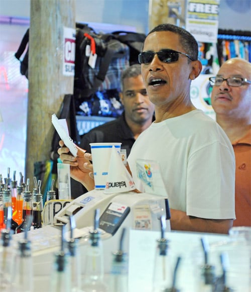 US President Barack Obama reads his order of shave ice from a piece of paper at Island Snow store in Kailua, Hawaii. The First Family is on vacation in Hawaii. (AFP Image)