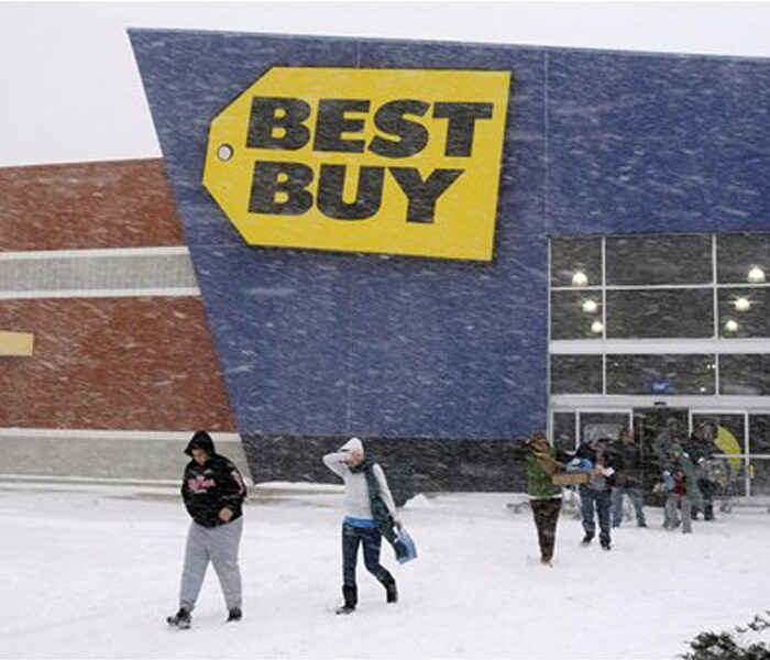 Shoppers leave a Best Buy store during a snow storm, on Saturday, in Philadelphia, US.<br><br>A blizzard-like storm rocked the Mid-Atlantic and Northeast on Saturday, crippling travel across the region and causing hundreds of thousands of power outages.<br><br>Those who did venture out were treated to nearly desolate stores on what is usually one of the busiest shopping days of the year.(AP photo)