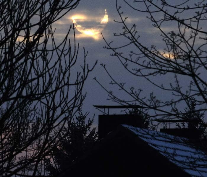 A partial solar eclipse is pictured through clouds in Bochum, western Germany. (AP Photo)