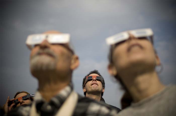 Israelis watch a partial solar eclipse in the town of Givatayim near Tel Aviv. A partial solar eclipse began in the skies over the Mideast and extended across much of Europe. (AP Photo)