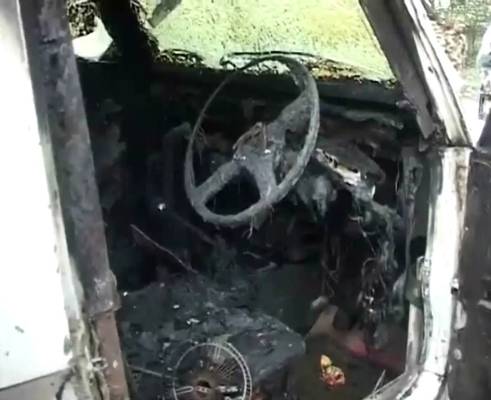 Remains of the charred police van which was torched by the angry mob.