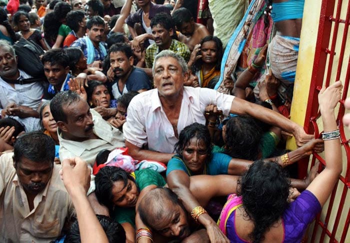 At least 27 pilgrims, most of them women, died on Tuesday morning after a stampede broke out at the banks of River Godavari in Andhra Pradesh on the first day of the religious festival Godavari  maha pushkaralu. (AFP Photo)