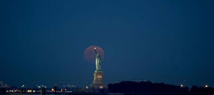 Supermoon over the Statue of Liberty in Manhattan, New York City. Photo Courtesy - The Boston Calendar