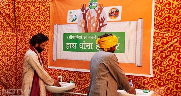 Pilgrims wash their hands at a Dettol handwashing station before taking the holy dip in the Ganges.