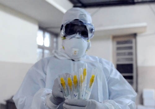 A medical technician checks samples collected from suspected H1N1 flu patients admitted to the Government Chest Hospital in Hyderabad. (AFP)