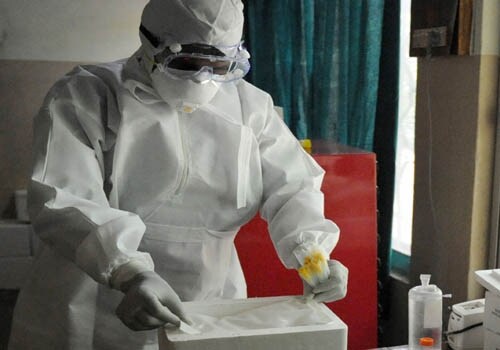 Medical technician places an icepack inside a thermocol box for samples collected from suspected patients of H1N1 flu admitted to the Government Chest Hospital in Hyderabad. (AFP)