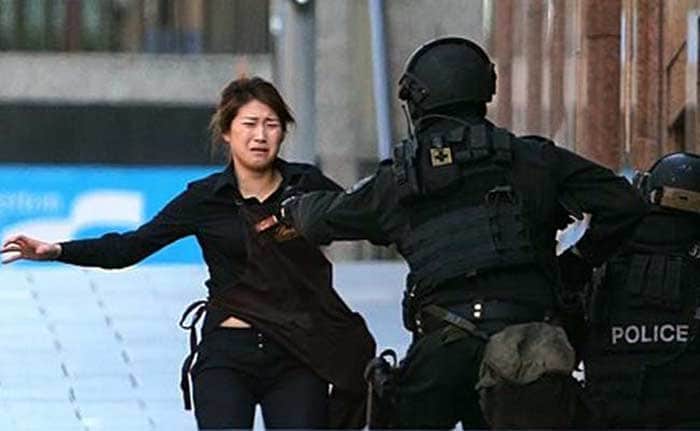 A handful of hostages ran out of the cafe to safety as the seige continued, but the acutal number of people held inside the cafe remained unclear.