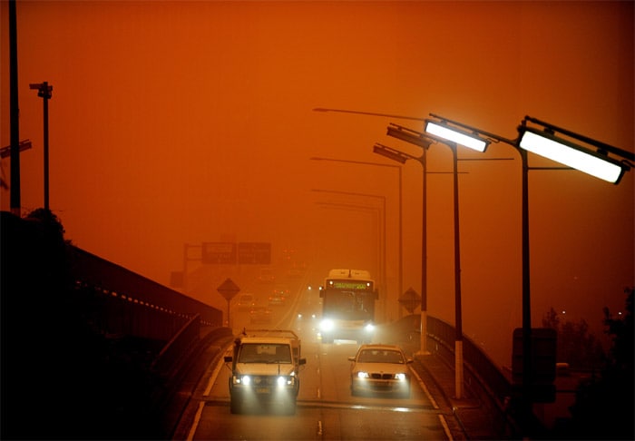 <strong>Caught in the wind:</strong> Traffic makes its way over the Cahill Expressway near Sydney as Australia's biggest city is shrouded in a a dust storm.<br />
<br />
Sydney's cars and buildings turned orange as strong winds blew desert dust across the city, snarling commuter and air transport and prompting a warning for children and the elderly to stay indoors. <em>(AFP)</em>