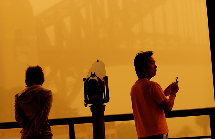 <strong>Not a great sight:</strong> A couple looks out onto the Sydney Harbour Bridge as Australia's worst dust storm in 70 years blanketed the city.<br />
<br />
The dust was still flying further north, however, and the sky over the Queens land state capital of Brisbane was clogged with dust into the early evening.<br />
<br />
People with asthma, heart or lung diseases were urged not to go outside and to keep their medicine inhalers handy. <em>(AFP)</em>