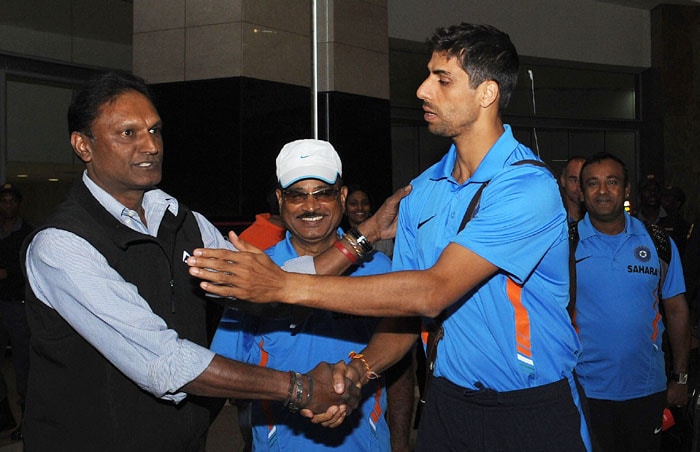 Ashish Nehra greets a fan in South Africa at Johannesburg airport ahead of the ICC Champions Trophy 2009. Nehra will be spearheading India pace attack in the absence of Zaheer Khan. (AFP Photo)