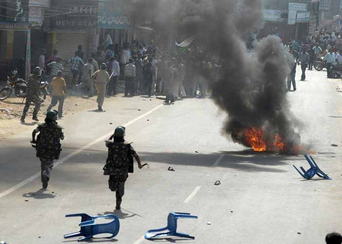 Police run to disperse supporters of united Andhra Pradesh pelting stones at the Congress party office during a protest against the formation of Telangana state, in Ananthapuram district some 400 kms from Hyderabad.