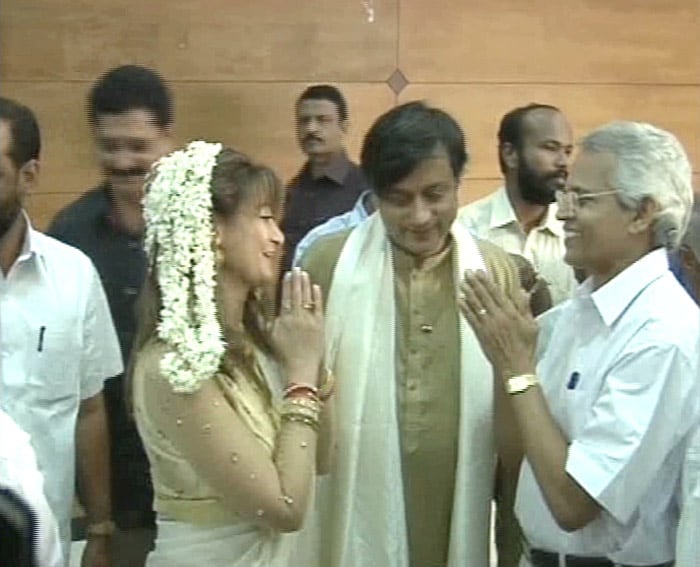 Sunanda responds to the warm blessings of the guests at the reception with Tharoor smiling aside.